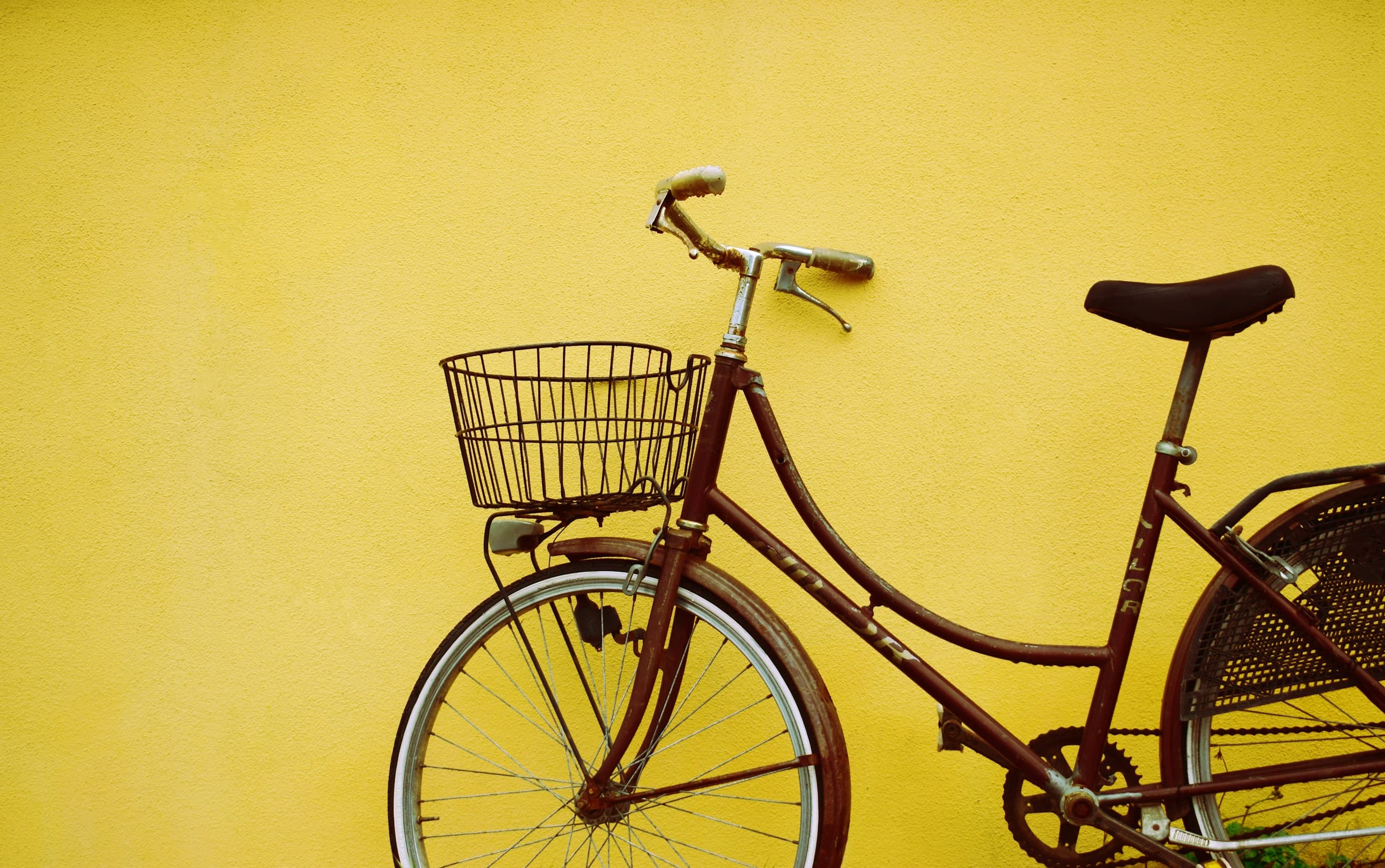 Yellow bike against a wall
